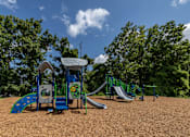 Thumbnail 10 of 12 - A playground with a blue slide and a green slide at Security Park Apartments*, Maryland, 21244
