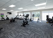 Thumbnail 15 of 19 - A gym with a variety of exercise equipment.