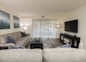 Thumbnail 3 of 25 - Living room with a couch and a tv at Ivy Hall Apartments*, Towson, MD 21204
