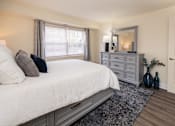 Thumbnail 11 of 16 - Bedroom with bed and dresser with window at Seminary Roundtop Apartments, Lutherville, 21093