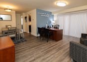 Thumbnail 6 of 16 - Dining room with hardwood laminate plank flooring and an office desk.