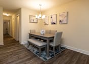 Thumbnail 4 of 25 - Dining room with a dining table and chairs and a wall with artwork at Village of Pine Run Apartments & Townhomes*, Maryland, 21244