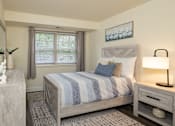 Thumbnail 9 of 25 - Second bedroom with bed, nightstand and window at Village of Pine Run Apartments & Townhomes*, Maryland, 21244