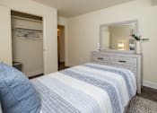 Thumbnail 11 of 25 - Second bedroom with bed, dresser with mirror, and closet at Village of Pine Run Apartments & Townhomes*, Maryland, 21244