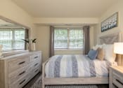Thumbnail 10 of 25 - Second bedroom with bed, nightstand, and window  at Village of Pine Run Apartments & Townhomes*, Maryland, 21244