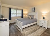 Thumbnail 14 of 25 - Primary bedroom with queen bed, nightstand, and window
 at Village of Pine Run Apartments & Townhomes*, Maryland, 21244