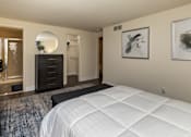 Thumbnail 13 of 32 - A bedroom with bed and dresser at Spring Hill Apartments & Townhomes, Baltimore, MD 21234