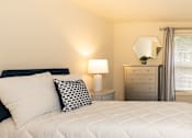 Thumbnail 18 of 32 - A bedroom with bed and windows at Spring Hill Apartments & Townhomes, Baltimore, MD 21234