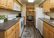 Thumbnail 9 of 32 - Galley kitchen with oven, dishwasher, refrigerator at Spring Hill Apartments & Townhomes, Baltimore, MD 21234.