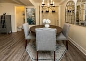 Thumbnail 7 of 32 - A dining room with a table and chairs.