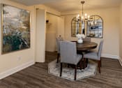 Thumbnail 6 of 32 - A dining room with a round table and chairs. Spring Hill Apartments & Townhomes, Baltimore, MD 21234