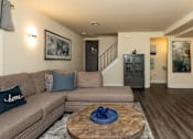 Thumbnail 3 of 32 - Living room with couch and coffee table at Spring Hill Apartments & Townhomes, Baltimore, MD 21234.