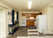 Thumbnail 9 of 22 - A kitchen with a white refrigerator and wooden cabinets.