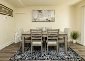 Thumbnail 8 of 22 - A dining room with a table and chairs.