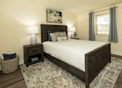 Thumbnail 11 of 22 - A bedroom with a large bed and a painting on the wall.
