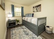 Thumbnail 19 of 22 - A bedroom with a bed, nightstand, and window.