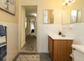 Thumbnail 17 of 22 - A bathroom with a white sink and a white bathtub.