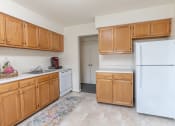 Thumbnail 4 of 15 - a kitchen with white appliances and wooden cabinets at Lawyers Hill Apartments, Elkridge, MD
