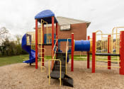 Thumbnail 12 of 15 - a playground with a blue and red slide and monkey bars at Lawyers Hill Apartments, Elkridge, MD, 21075
