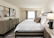 Thumbnail 17 of 28 - Bedroom with a bed and dressers at Ivy Hall Apartments*, Towson, MD 21204