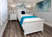 Thumbnail 12 of 24 - A bedroom with a bed and two night stands at Fairbrook Park, Baltimore, MD