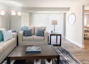 Thumbnail 3 of 24 - A living room with white walls and a blue and white rug at Fairbrook Park, Baltimore, MD 21244