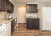 Thumbnail 6 of 24 - A kitchen with white appliances and brown cabinets at Fairbrook Park, Maryland, 21244