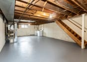 Thumbnail 19 of 22 - Large unfinished basement with washer and dryer at Foxridge Townhomes, Baltimore