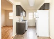 Thumbnail 3 of 22 - A kitchen with a white refrigerator at Foxridge Townhomes, Maryland, 21221