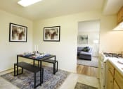 Thumbnail 4 of 12 - a living room with a dining table and a kitchen with a couch at Arbuta Arms Apartments*, Maryland
