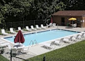 Thumbnail 24 of 25 - a swimming pool with chairs and an umbrella next to it