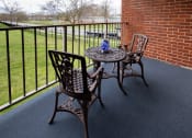 Thumbnail 19 of 23 - Balcony with two chairs at Rockdale Gardens Apartments*, Baltimore, MD