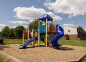 Thumbnail 23 of 23 - Playground with two slides and a climbing structure at The Orchards at Severn Townhomes*, Severn, MD 21144