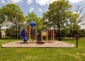 Thumbnail 21 of 23 - Playground with a blue slide and monkey bars at The Orchards at Severn Townhomes*, Maryland
