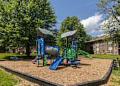 Thumbnail 23 of 27 - A playground with a blue slide and a green slide.at Deer Park Apartments, Randallstown, MD 21133