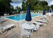 Thumbnail 20 of 25 - Community pool with lounge chairs at McDonogh Village Apartments & Townhomes, Randallstown, Maryland