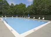 Thumbnail 27 of 31 - Beautiful private swimming pool with lounge chairs  at Spring Hill Apartments & Townhomes, Baltimore, MD 21234