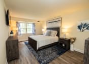 Thumbnail 9 of 29 - Primary bedroom with a queen bed, dresser, and window in Randallstown, MD 21133.