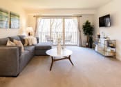Thumbnail 3 of 21 - Living room with a gray couch and a white coffee table at Village of Pine Run Apartments & Townhomes*, Maryland