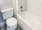 Thumbnail 17 of 25 - Bathroom with a toilet and a bathtub at McDonogh Village Apartments & Townhomes, Randallstown, 21133