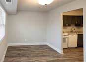 Thumbnail 8 of 25 - A bedroom with a window and a kitchen at McDonogh Village Apartments & Townhomes, Randallstown, MD
