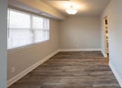 Thumbnail 9 of 25 - Bedroom with a hardwood floor and a large window at McDonogh Village Apartments & Townhomes, Randallstown, 21133