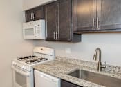 Thumbnail 2 of 25 - A kitchen with white appliances at McDonogh Village Apartments & Townhomes, Randallstown, Maryland, 21133