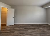 Thumbnail 12 of 25 - Bedroom with grey walls and a wooden floor at McDonogh Village Apartments & Townhomes, Randallstown, Maryland
