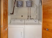 Thumbnail 7 of 31 - A small laundry room with a washer and dryer.