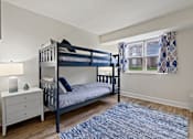 Thumbnail 10 of 19 - A bedroom with a bunk bed and a dresser at Woodsdale Apartments in Abingdon, MD