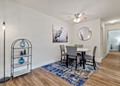 Thumbnail 5 of 19 - A dining room with a table set for four at Woodsdale Apartments in Abingdon, MD