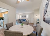 Thumbnail 4 of 19 - A modern dining room with a round table and chairs at Woodsdale Apartments in Abingdon, MD
