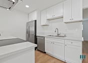 Thumbnail 9 of 30 - Kitchen with Stainless-Steel Refrigerator, Dishwasher, and Stove
