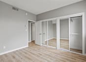 Thumbnail 12 of 62 - Bedroom with Mirrored Closets and Vinyl Flooring